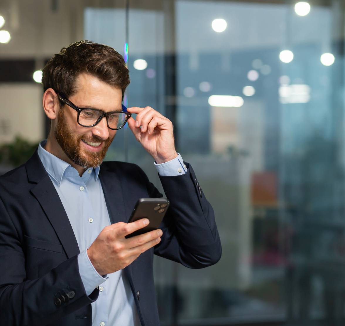 man-with-glasses-smiling-at-phone